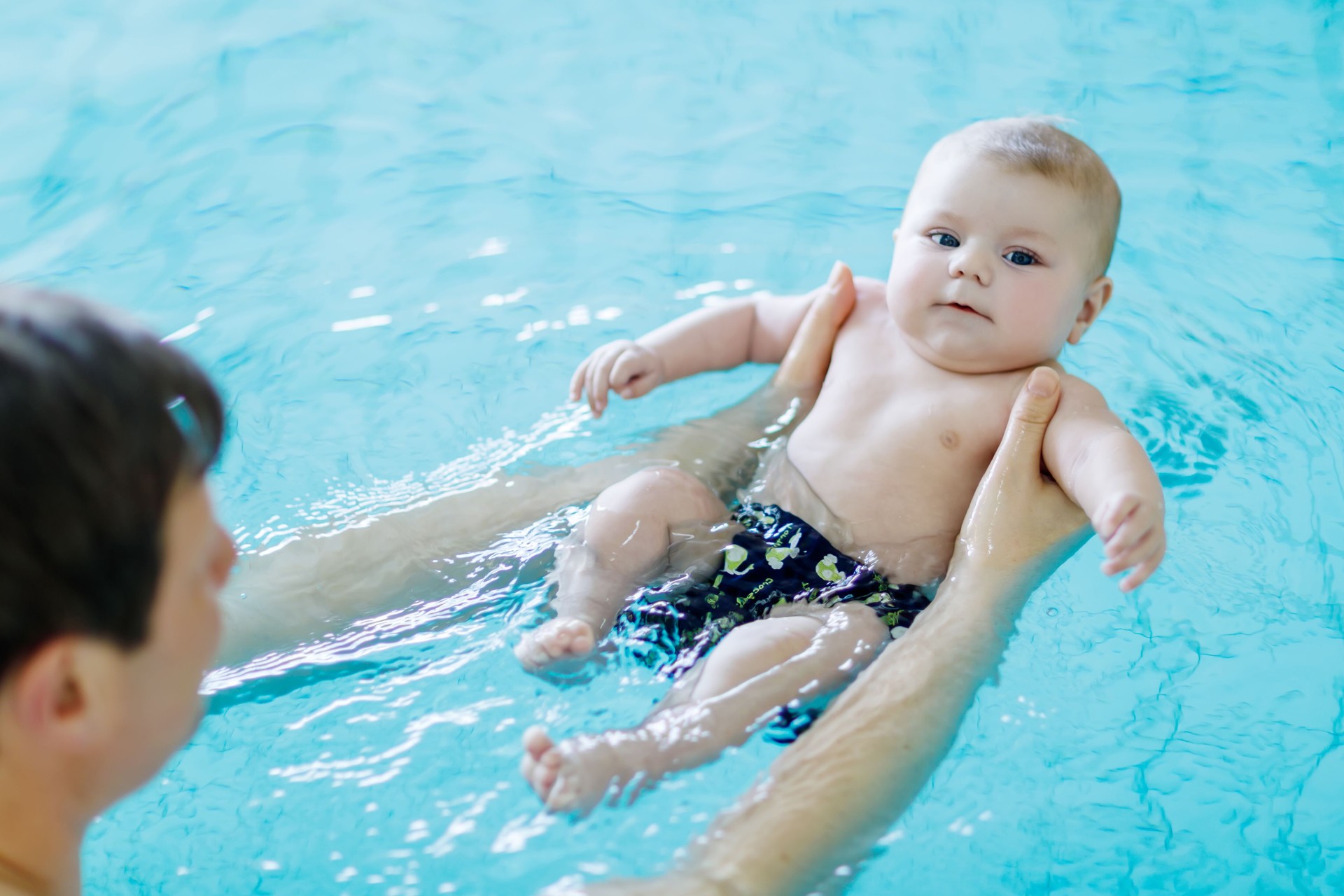  adorable baby in swimming pool in swim nappies